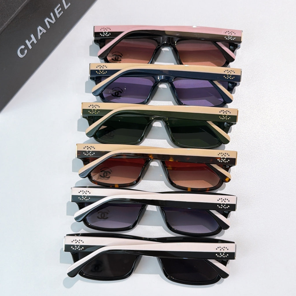 Stacked sunglasses with assorted colors, tinted lenses, and Chanel logos on temples
