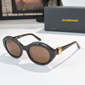 Black tortoiseshell round cat-eye sunglasses with brown tinted lenses and gold hinge