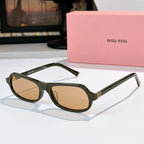Sunglasses with dark green frame and tan tinted lenses, rounded cat-eye shape