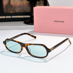 Sunglasses with tortoiseshell frame and light blue tinted lenses, rounded cat-eye shape