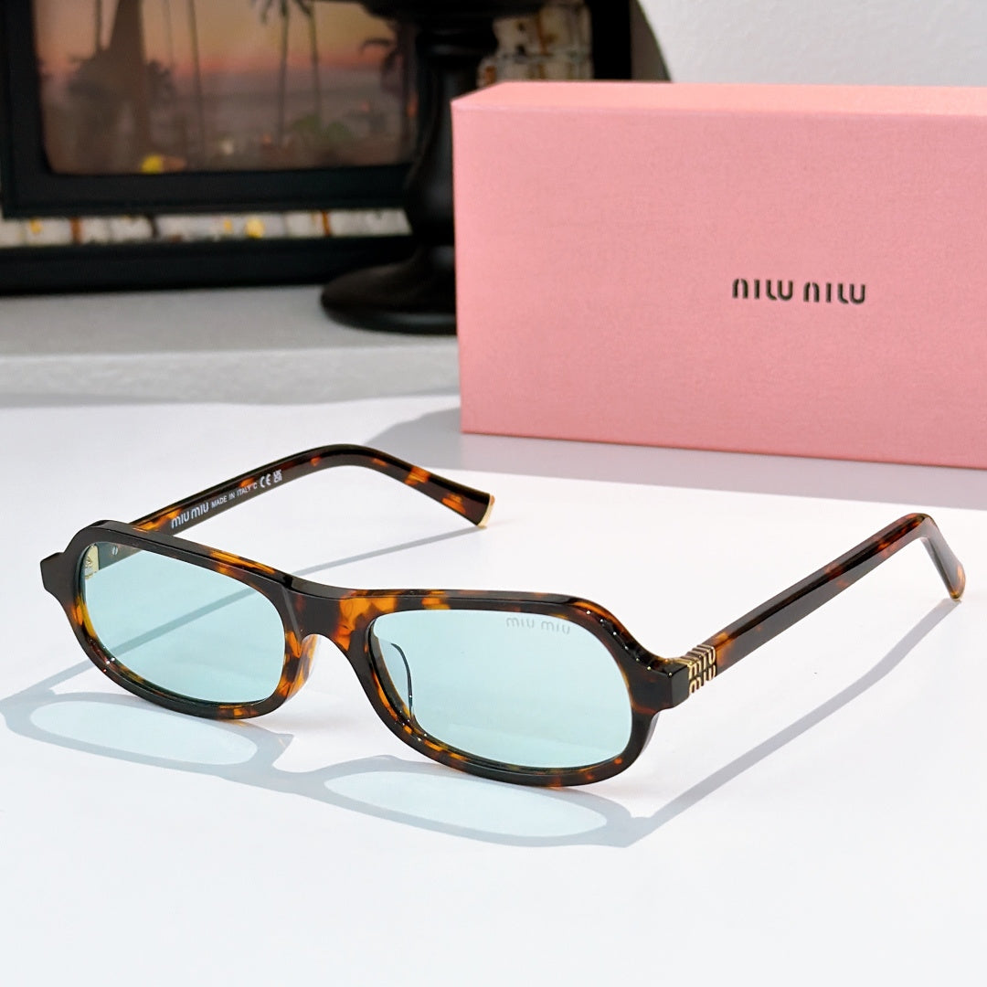 Sunglasses with tortoiseshell frame and light blue tinted lenses, rounded cat-eye shape