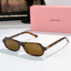 Sunglasses with tortoiseshell frame and amber tinted lenses, rounded cat-eye shape