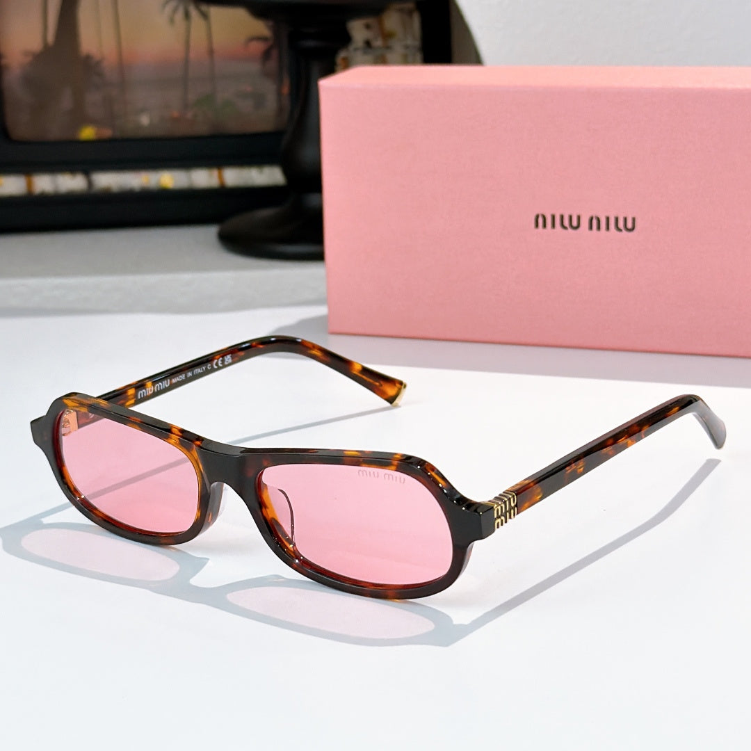 Sunglasses with tortoiseshell frame and pink tinted lenses, rounded cat-eye shape