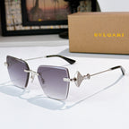 Bvlgari sunglasses with gray-purple lenses, silver frame, jeweled bridge detail.