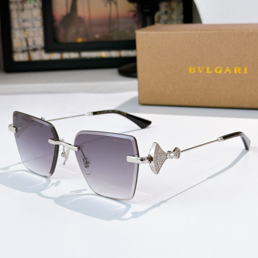 Bvlgari sunglasses with gray-purple lenses, silver frame, jeweled bridge detail.