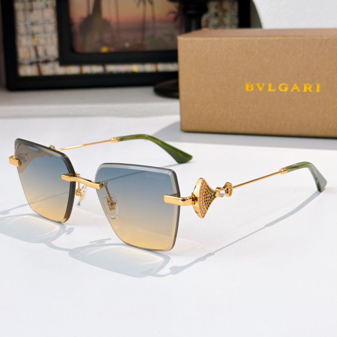 Bvlgari sunglasses with blue gradient lenses, gold frame, jeweled bridge detail.