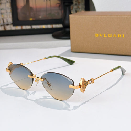 Bvlgari sunglasses with gold-tone frame and blue gradient lenses.