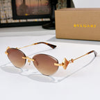 Bvlgari sunglasses with gold-tone frame and brown gradient lenses.