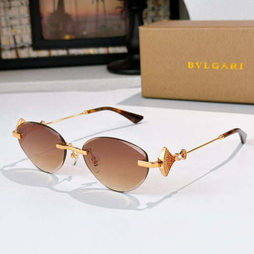 Bvlgari sunglasses with gold-tone frame and brown gradient lenses.