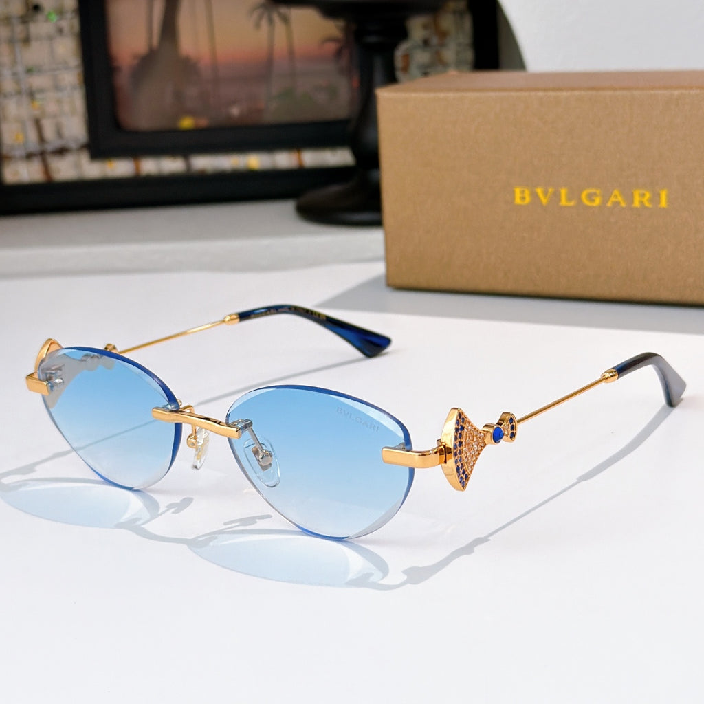 Bvlgari sunglasses with gold-tone frame and light blue gradient lenses.