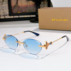 Bvlgari sunglasses with gold-tone frame and light blue gradient lenses.