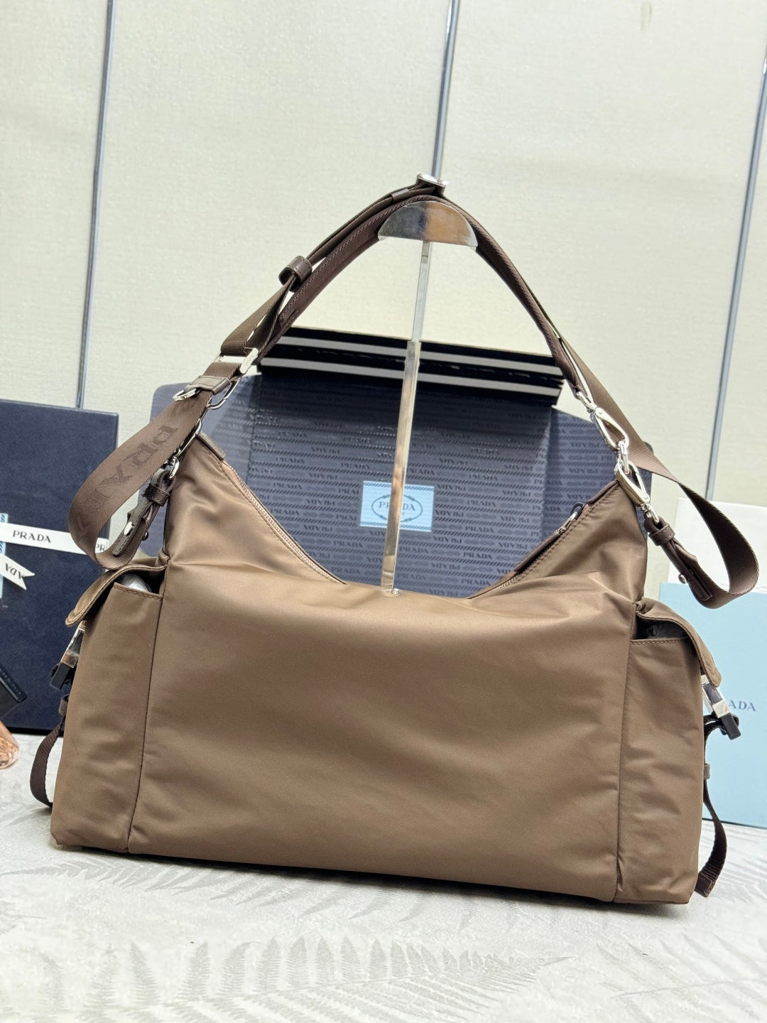 Taupe nylon shoulder bag with wide strap and top handle, front view