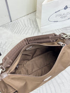 Open interior of taupe nylon bag with zipper, silver pull, and fabric lining