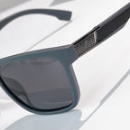 Prada sunglasses close-up of textured temple and dark gray lens