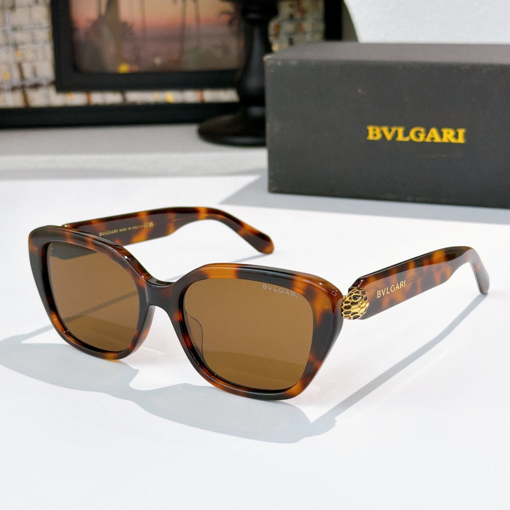 Amber tortoise square eyeglasses with brown lenses and gold logo detail