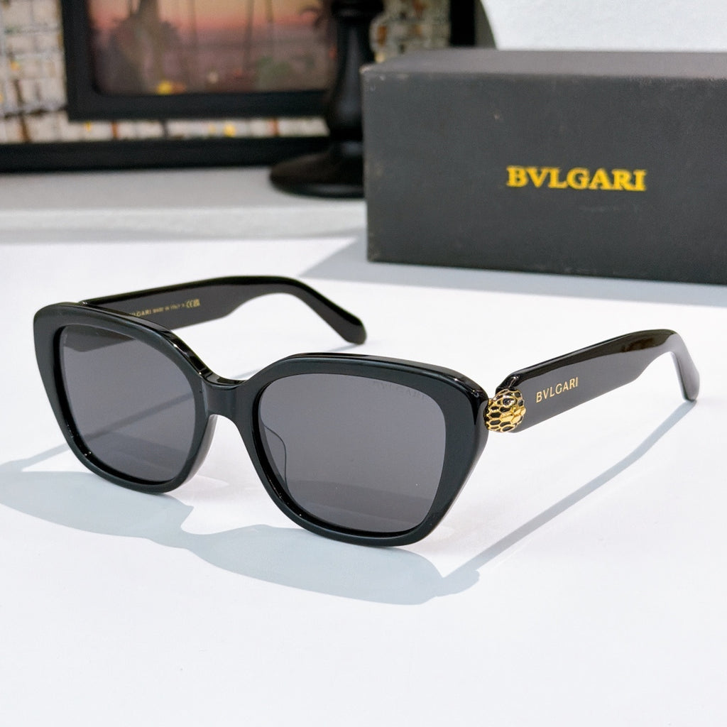 Black square eyeglasses with dark lenses and gold logo detail