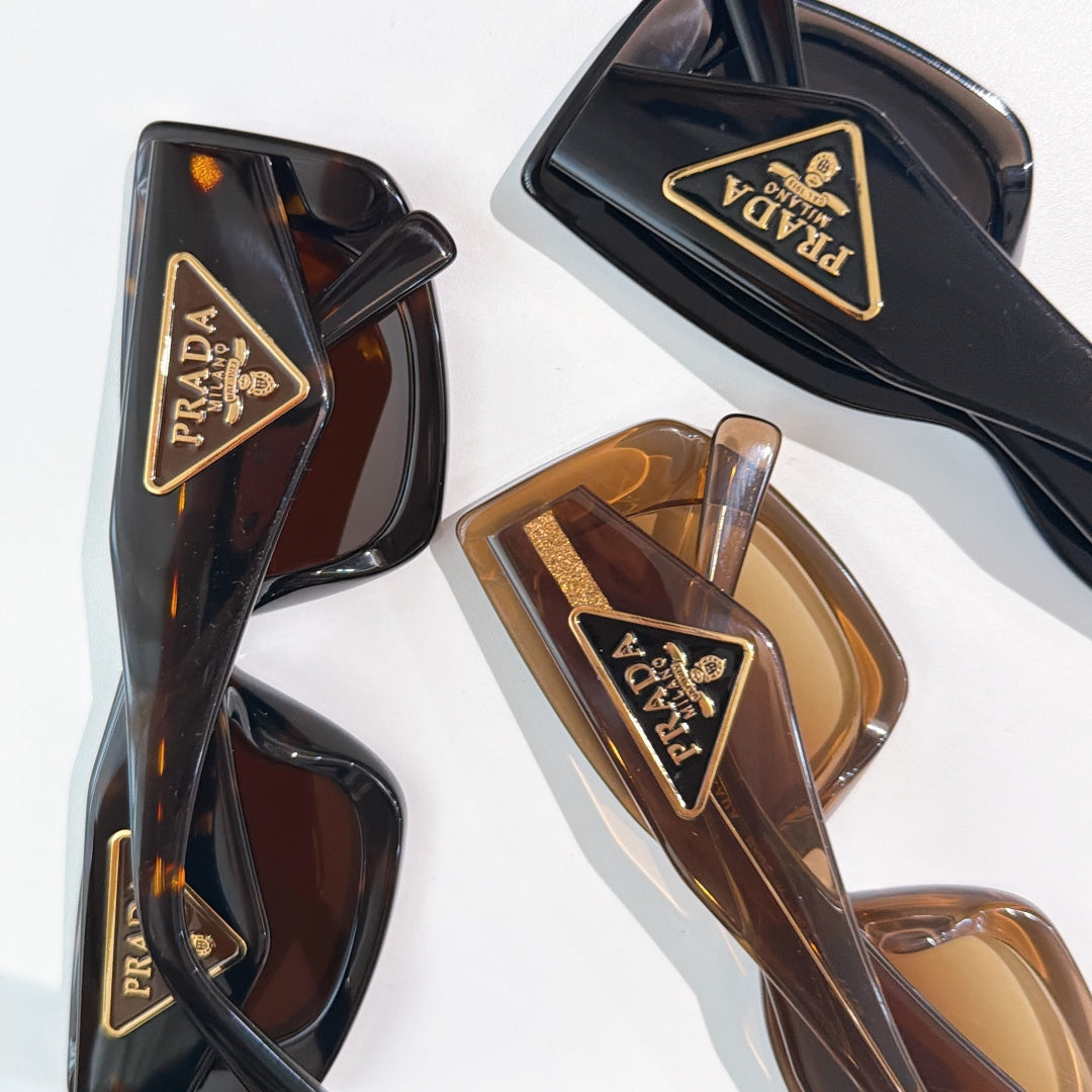 PRADA sunglasses frames close-up with triangular logo accents and tinted lenses