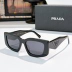 PRADA black cat-eye sunglasses with logo badge and dark tinted lenses