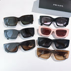 Assorted PRADA sunglasses with mixed frames and tinted lenses, shown together