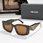 PRADA dark tortoiseshell cat-eye sunglasses with logo badge and amber tinted lenses