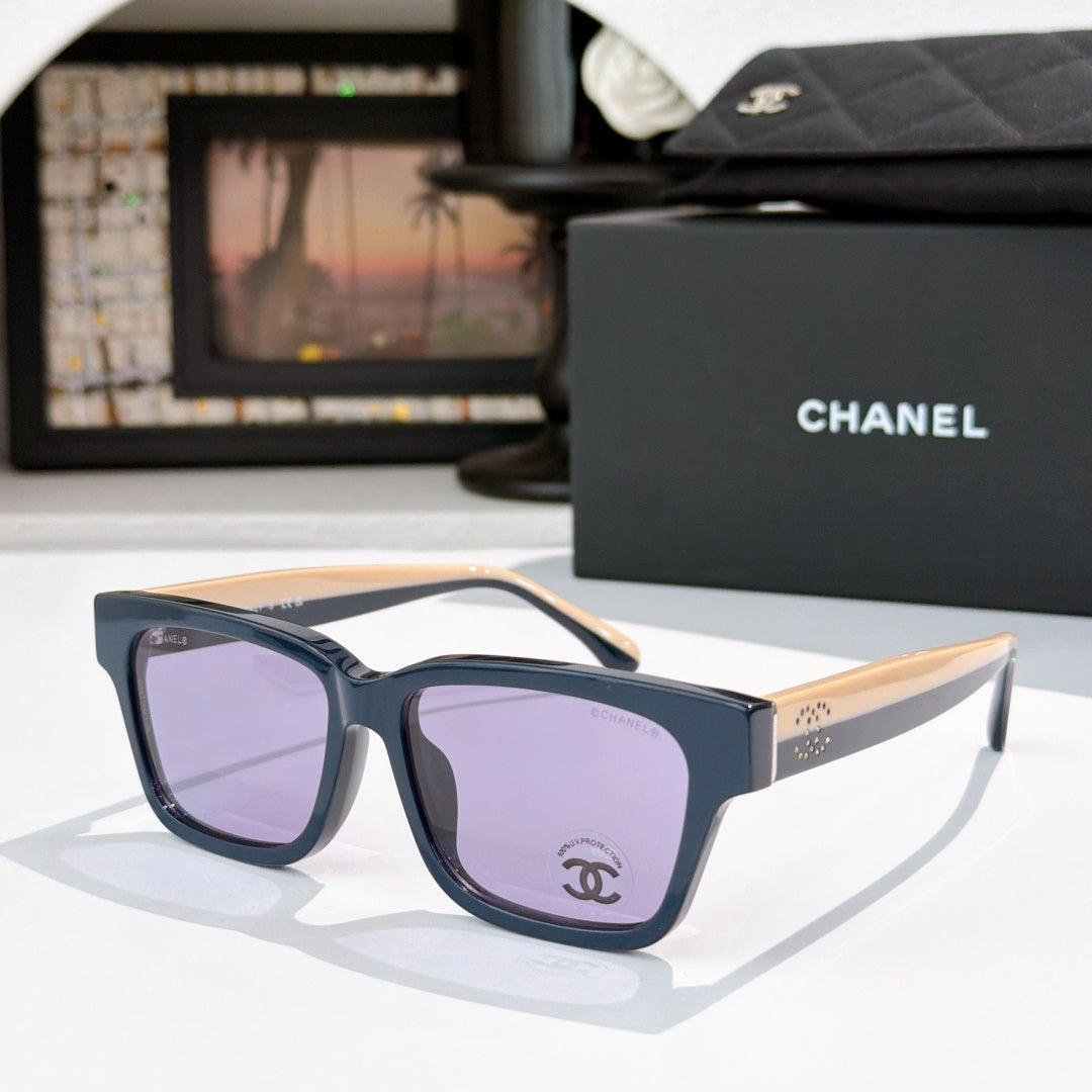 CHANEL cat-eye sunglasses, dark blue-gray frames, lavender-tinted lenses, cream temples