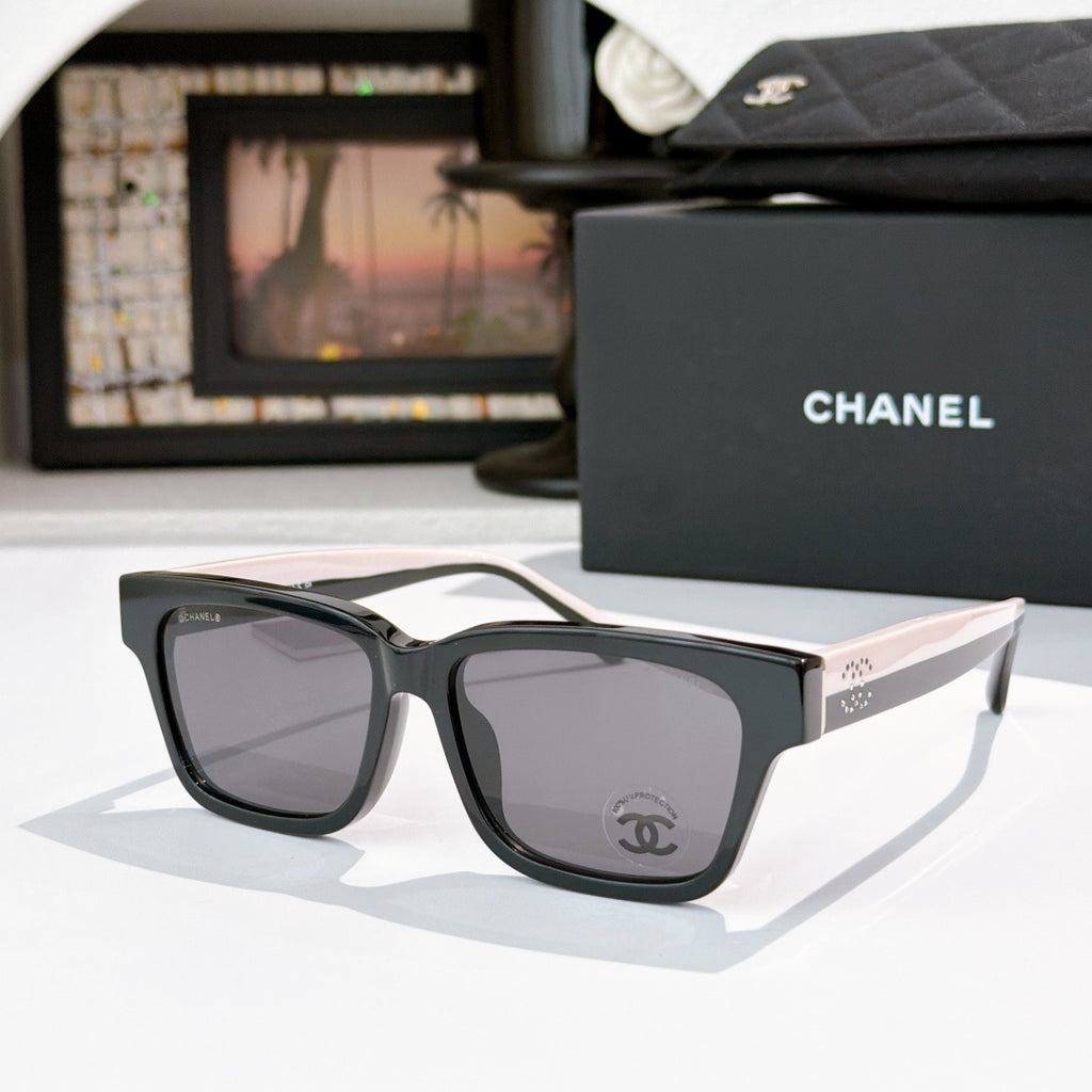 CHANEL cat-eye sunglasses, black frames with gray-tinted lenses, pale pink temples
