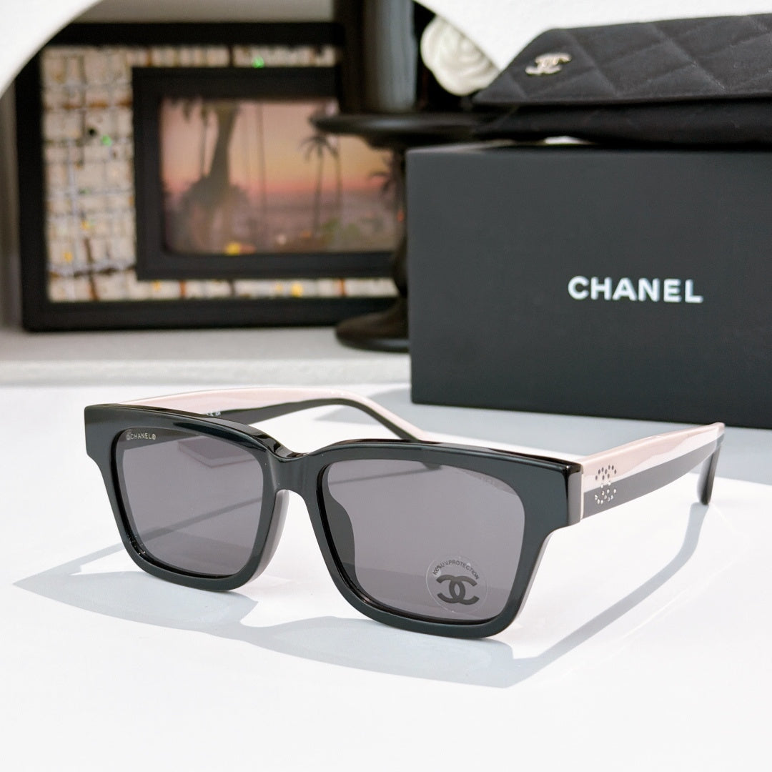 CHANEL cat-eye sunglasses, black frames with gray-tinted lenses, pale pink temples