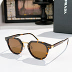 Prada glasses, tortoiseshell frames with amber-tinted lenses and gold accents