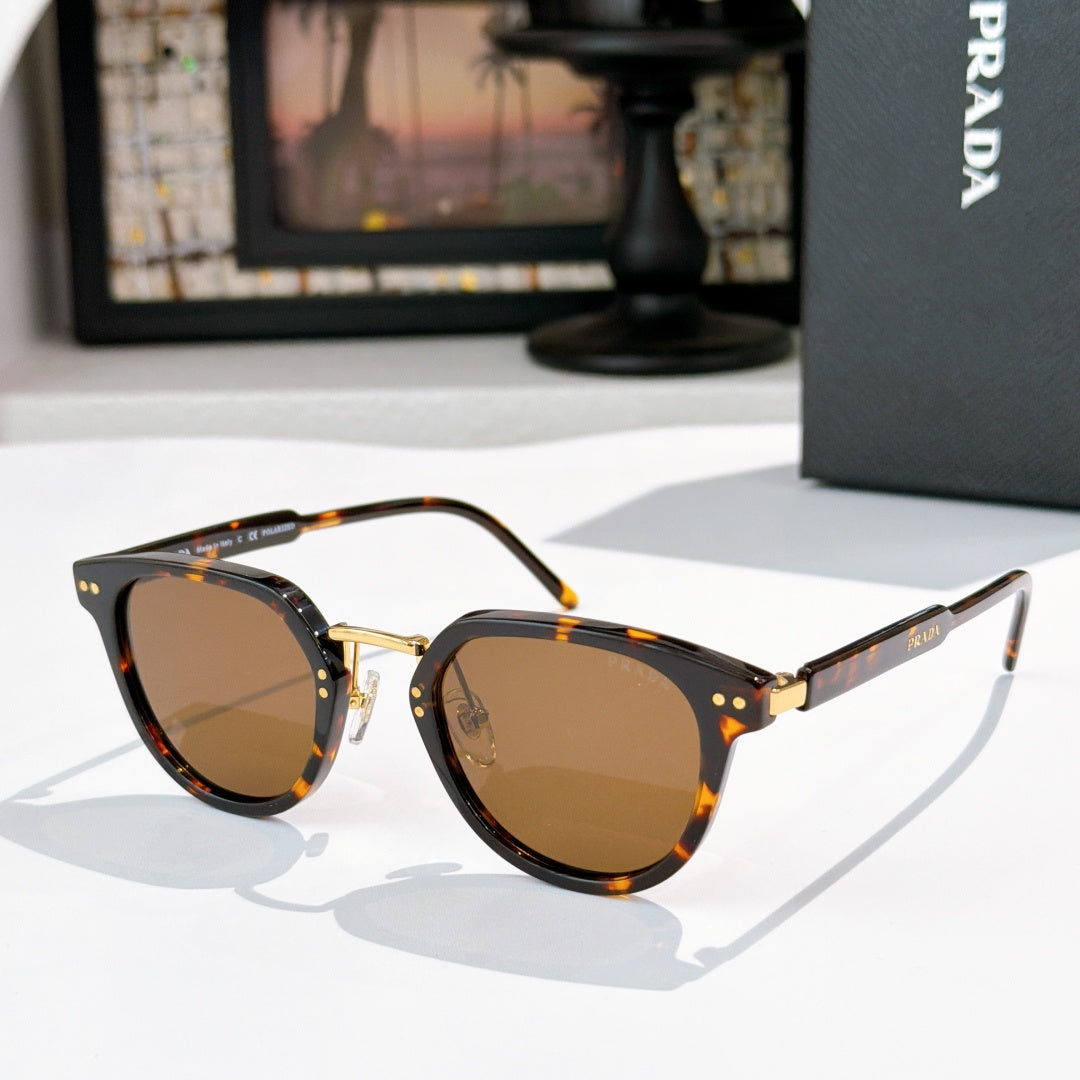 Prada glasses, tortoiseshell frames with amber-tinted lenses and gold accents