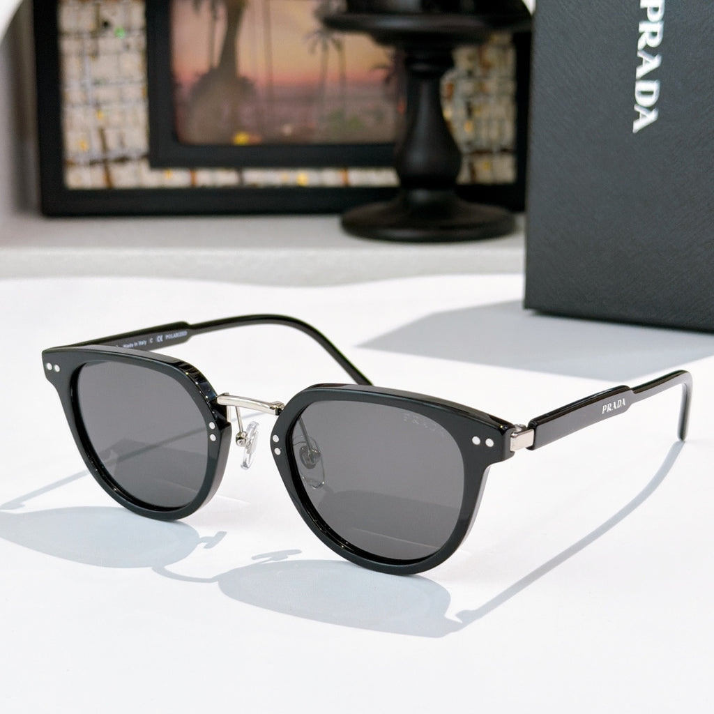 Prada glasses, dark frames with smoke lenses and gold bridge hardware
