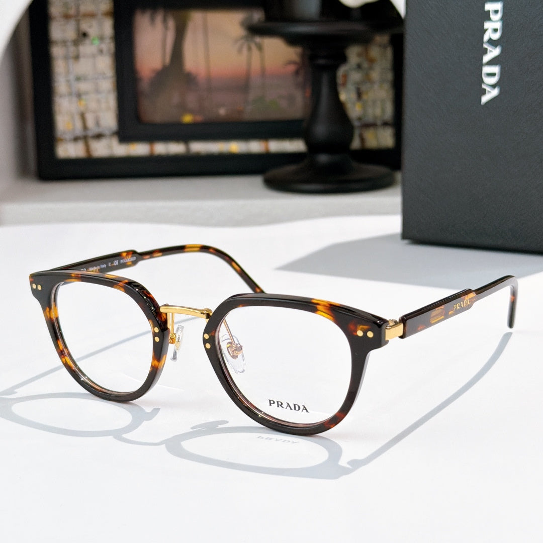 Prada glasses, tortoiseshell frames with clear lenses and gold bridge accents