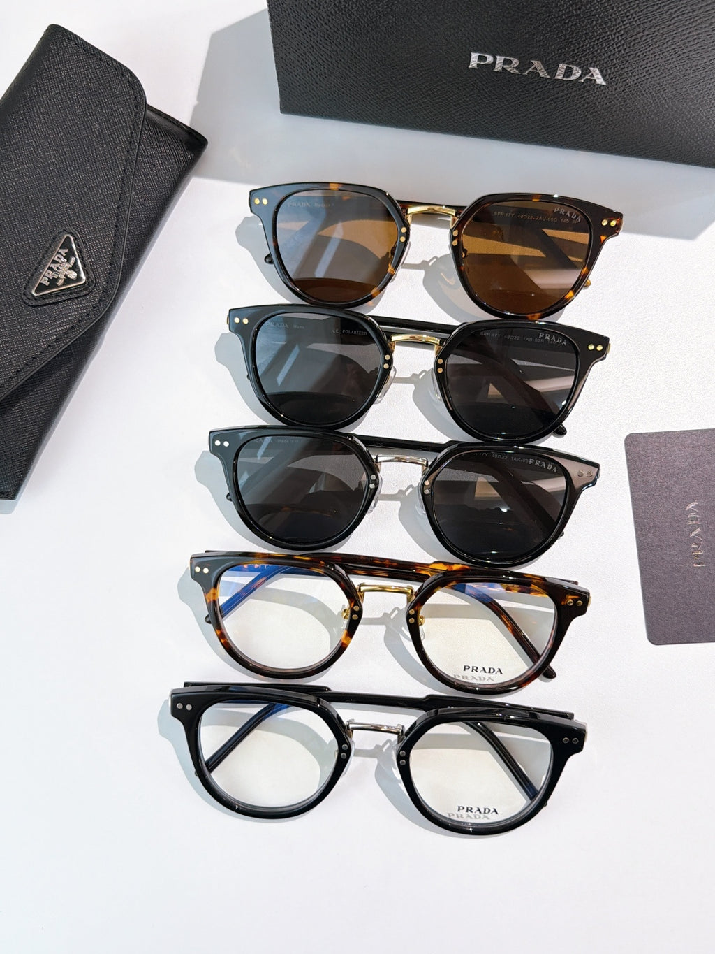 Prada glasses lineup, mixed frames with tinted and clear lenses