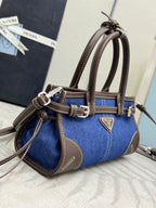 Blue denim Prada handbag side view with brown leather handles and logo triangle