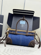 Blue denim Prada handbag with top handle, crossbody strap, and logo hardware