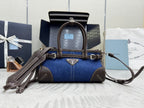Blue denim Prada handbag with brown leather handles and shoulder strap