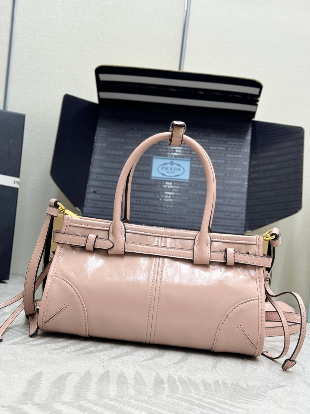 Prada mini tote bag, light pink, front buckle details, top handle, long crossbody strap