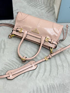 Prada light pink mini bag with front belt strap, crossbody strap, gold hardware
