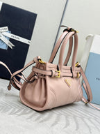 Prada light pink mini tote bag with two top handles, gold buckles, adjustable strap