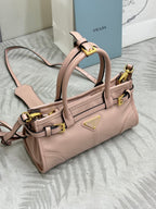 Prada light pink mini tote bag with gold buckle straps and front logo detail