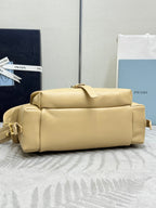 Beige leather bag with structured top, short handles, and gold hardware accents