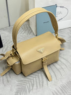 Beige leather shoulder bag with flap closure and triangular logo plate on front