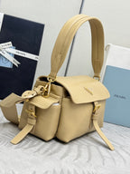 Beige leather tote-style bag with dual handles, flap front, and gold hardware
