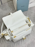White Prada small shoulder bag with flap, zipper pocket, and gold hardware