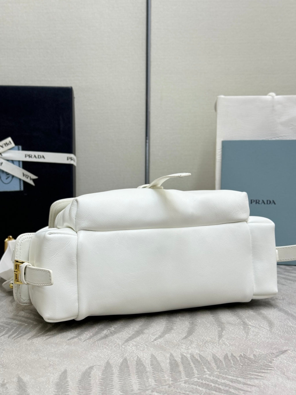 White Prada handbag with structured shape and top zipper closure