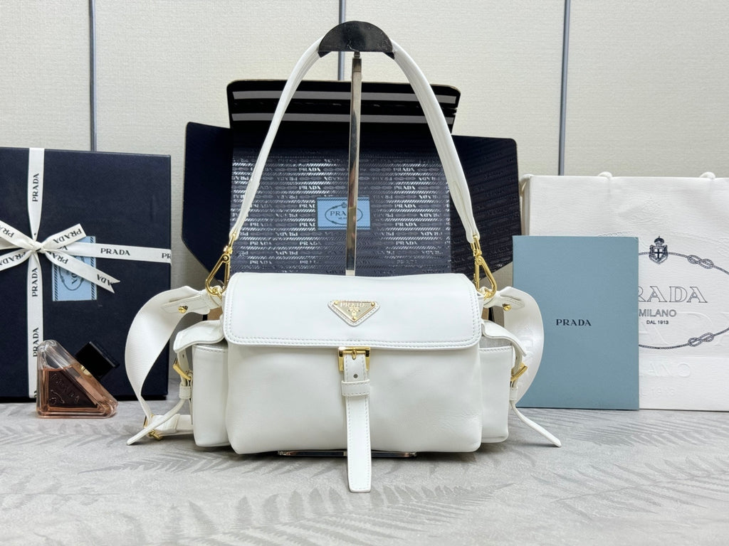 White Prada handbag with top handle, shoulder straps, and logo plaque