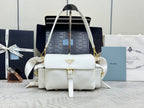 White Prada handbag with top handle, shoulder straps, and logo plaque