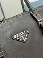 Prada gray leather handbag triangle logo metal plate on textured leather.
