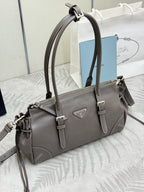 Prada gray leather handbag with top handles, front logo plate, and shoulder strap.