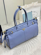 Light blue Prada handbag with top handles and adjustable shoulder strap, gold details