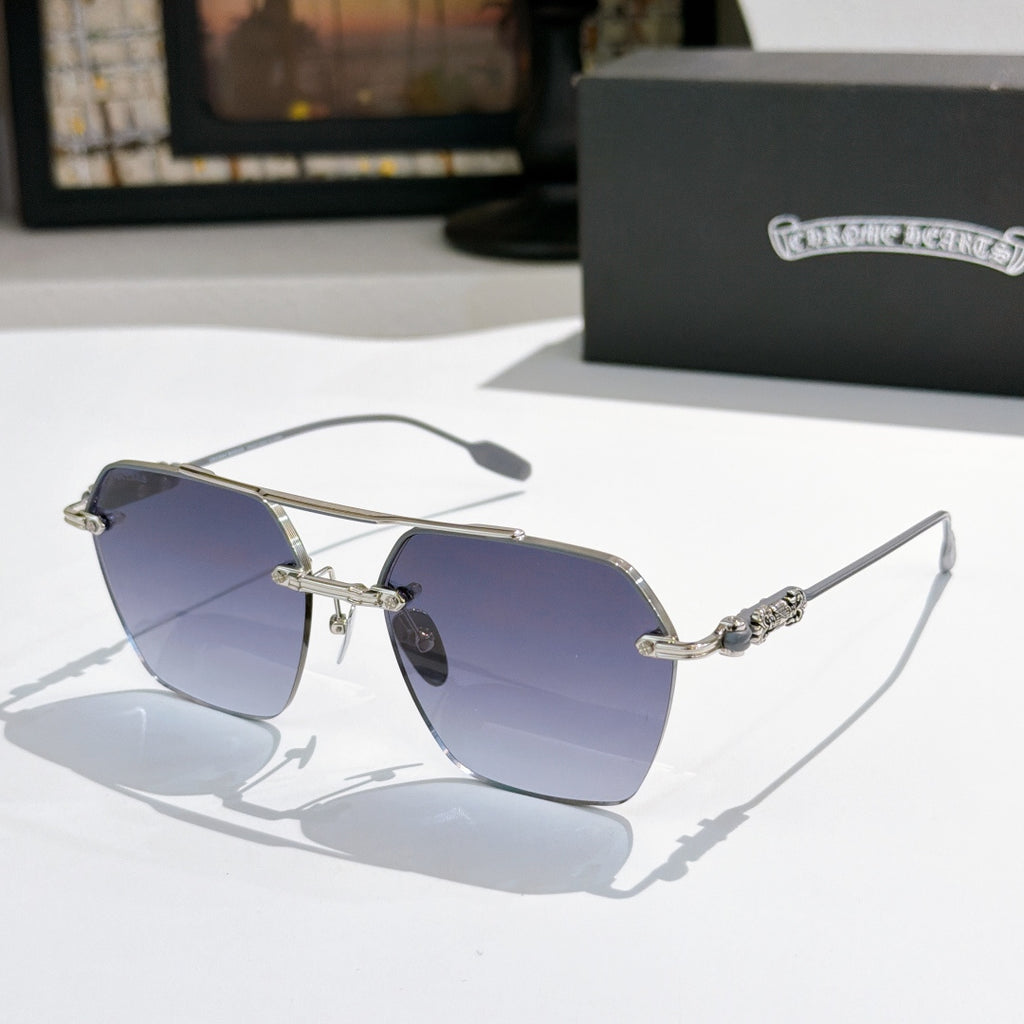 Chrome metal sunglasses with blue tinted lenses and ornate silver temple details